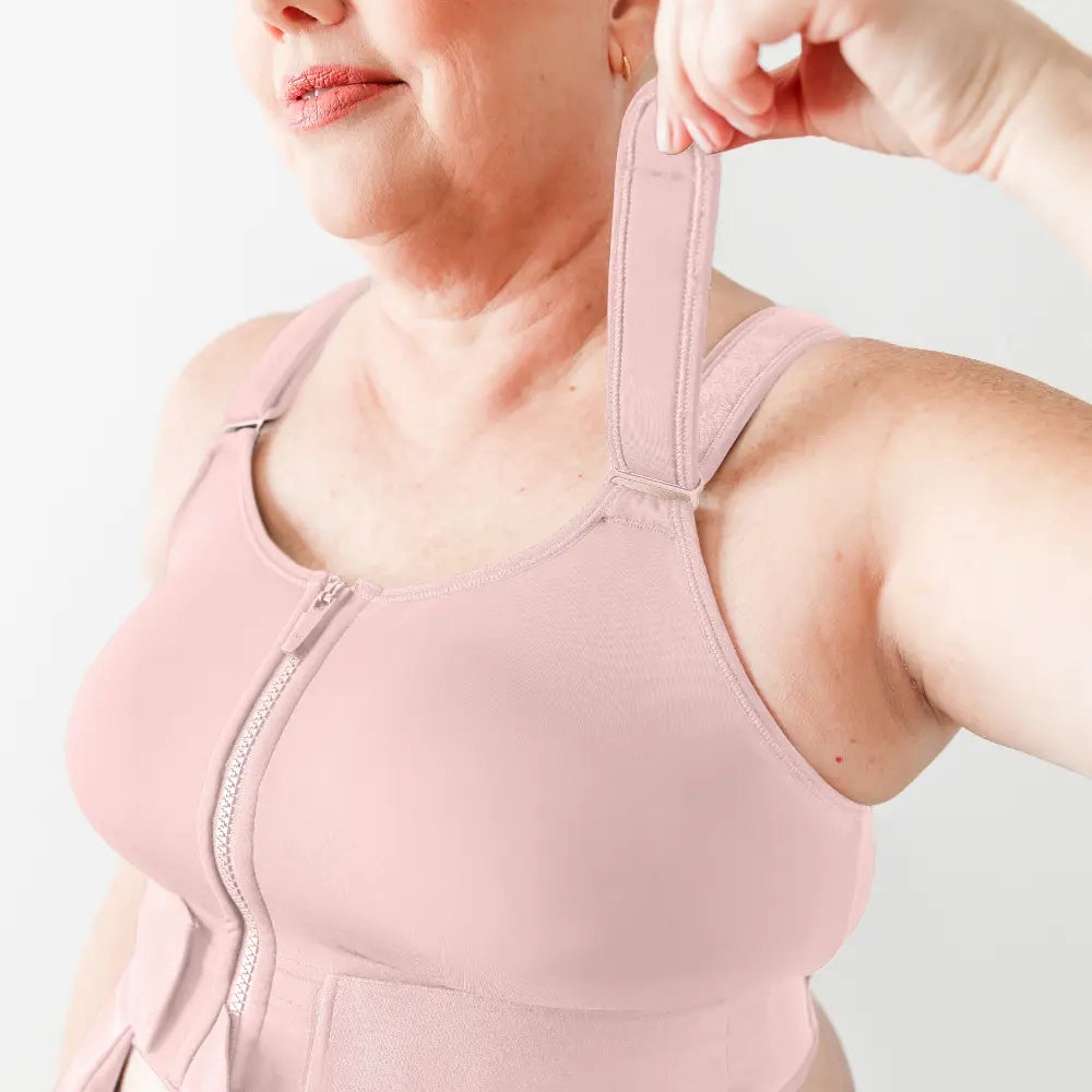 Person wearing a pink compression garment with a close-up of the chest area.